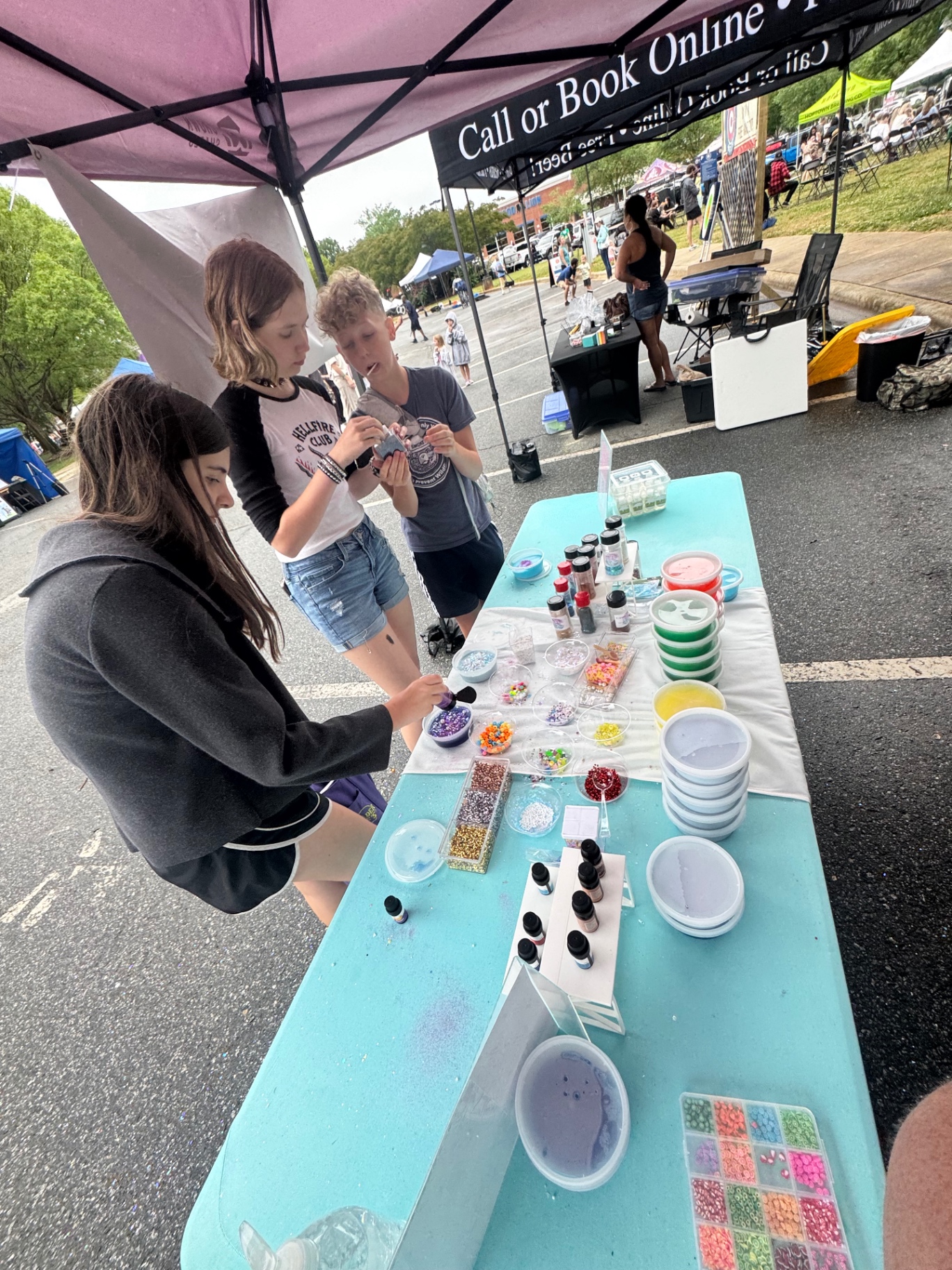 Kids making custom slime at a Lake Norman Slime Co. event