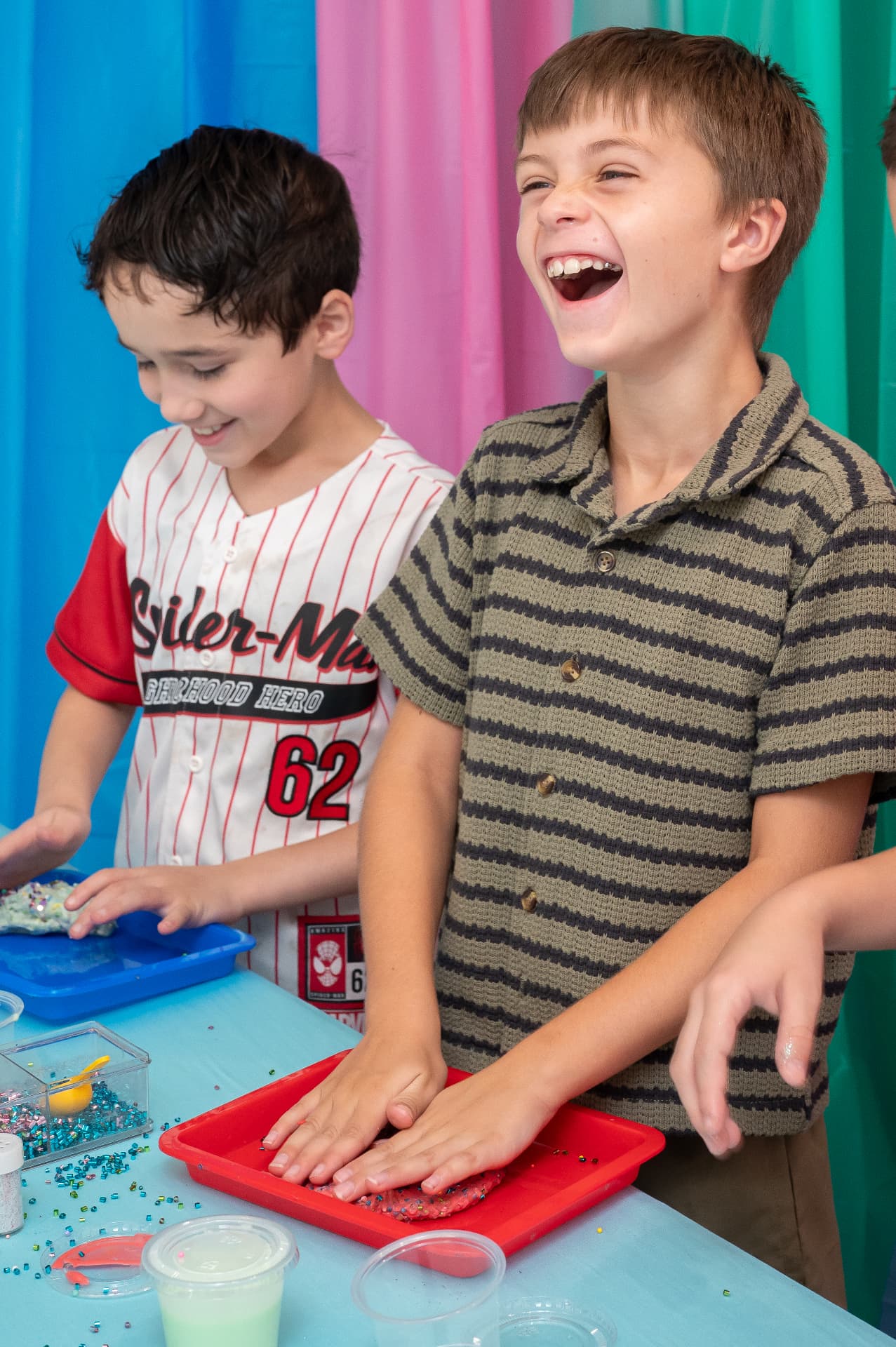 Kids laughing while making slime at a birthday party